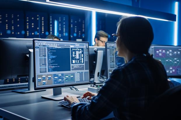 female computer programmer in front of monitor