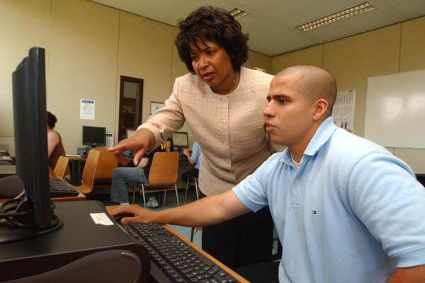 Soldier uses a computer in college.