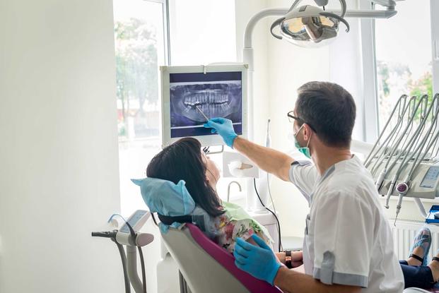 Dentist with patient in chair