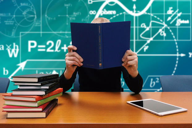 image of man studying by reading book